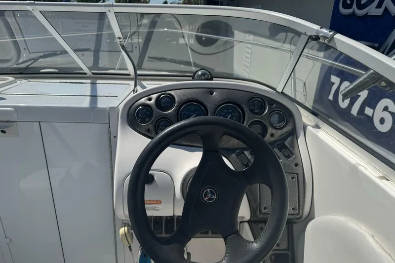 Slide: The Image of Steering console of a 2002 Campion Explorer 602 Sport Cabin boat, featuring multiple gauges. - 16