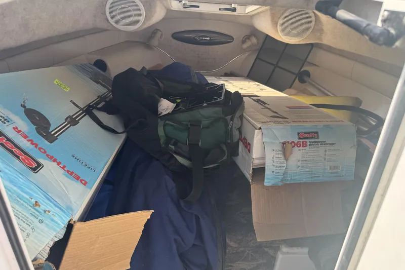 Slide: The Image of Interior of 2002 Campion Explorer 602 Sport Cabin with boxes and gear. - 20