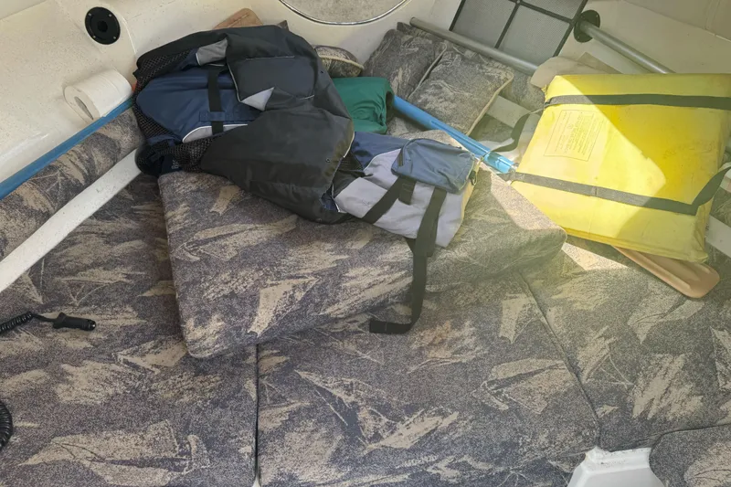 Slide: The Image of Interior of 2002 Campion Explorer 602 Sport Cabin with life jackets and gear. - 23