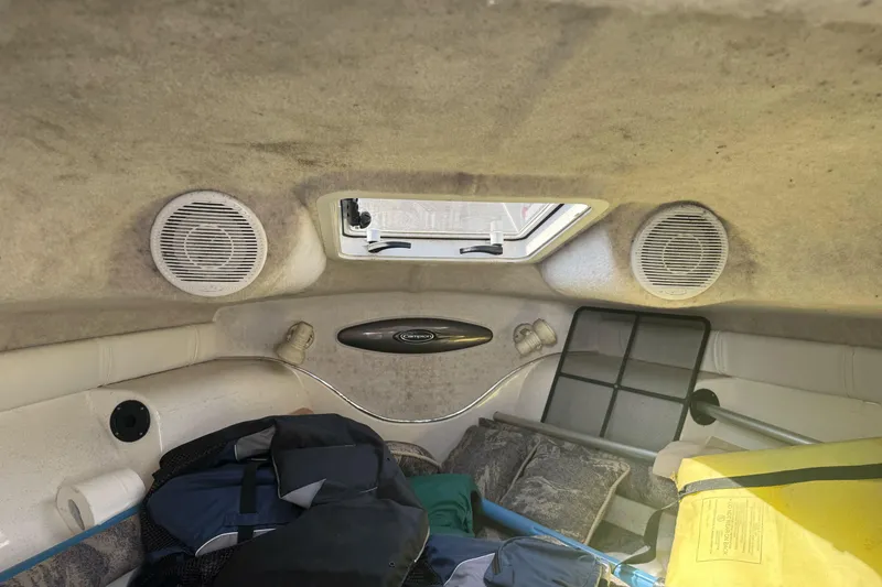 Slide: The Image of Interior of 2002 Campion Explorer 602 Sport Cabin with speakers and storage items. - 24