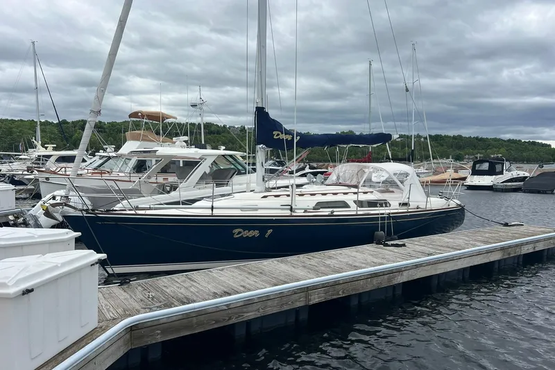 The Image of 1998 Sabre 362 sailboat docked at a marina under cloudy skies. - 0