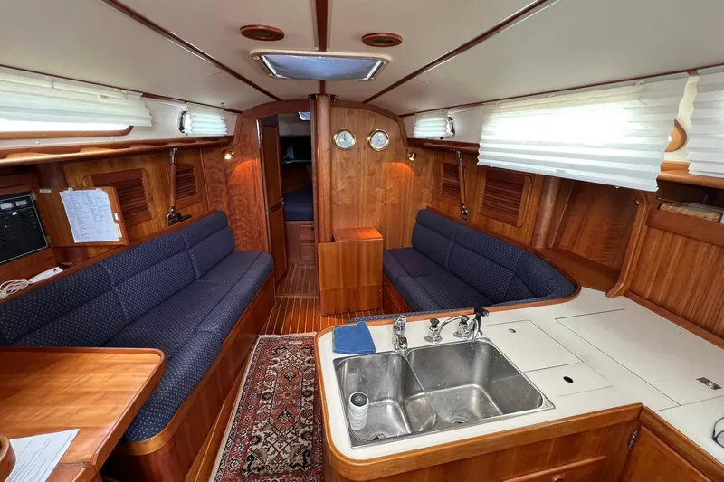 Slide: The Image of Interior of a 1998 Sabre 362 sailboat with wooden finish and cozy seating. - 20