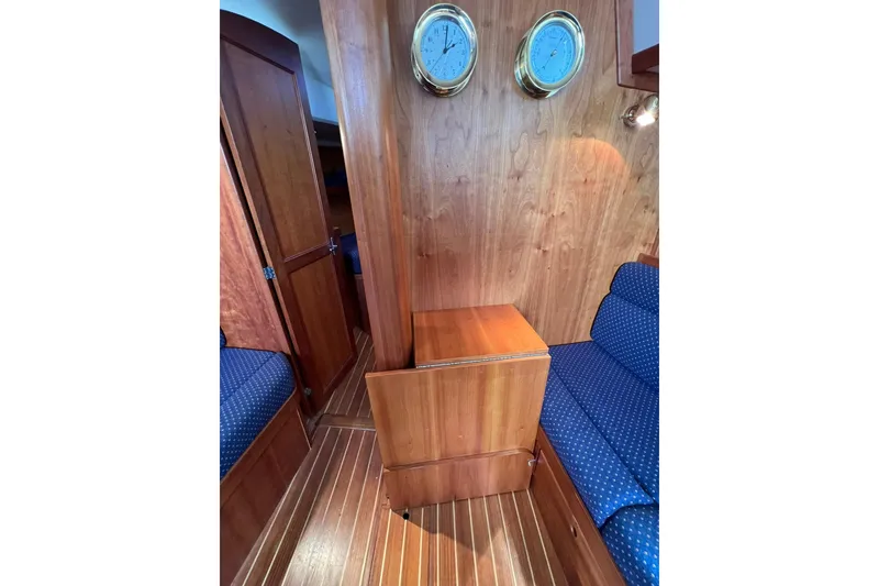 Slide: The Image of Interior of 1998 Sabre 362 yacht with wooden paneling and blue upholstered seating. - 22