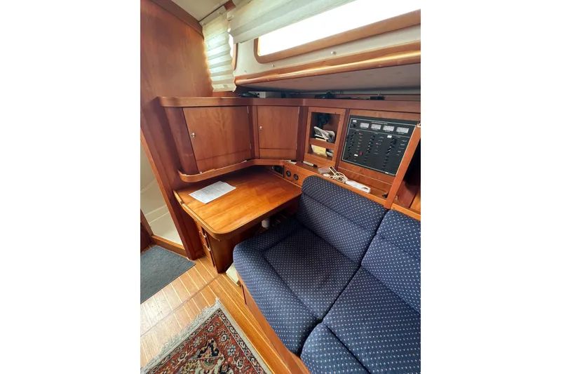 Slide: The Image of Interior of 1998 Sabre 362 yacht with wooden cabinetry and blue upholstered seating. - 24
