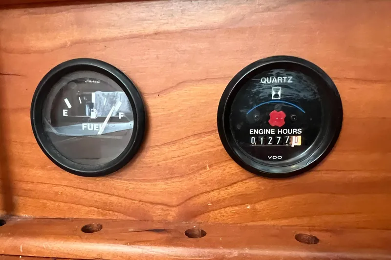 Slide: The Image of Fuel and engine hour gauges on a 1998 Sabre 362 boat dashboard. - 26