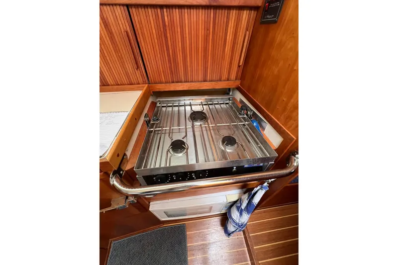 Slide: The Image of 1998 Sabre 362 yacht kitchen with stainless steel stove and wooden cabinetry. - 28