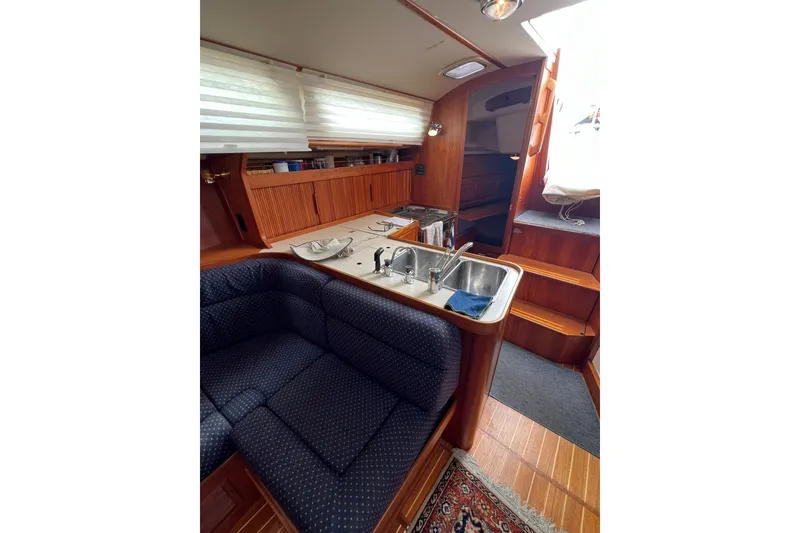 Slide: The Image of Interior of 1998 Sabre 362 yacht with cozy seating and kitchen area. - 29