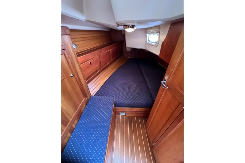 Slide: The Image of 1998 Sabre 362 yacht cabin with wooden interior and cozy sleeping area. - 30