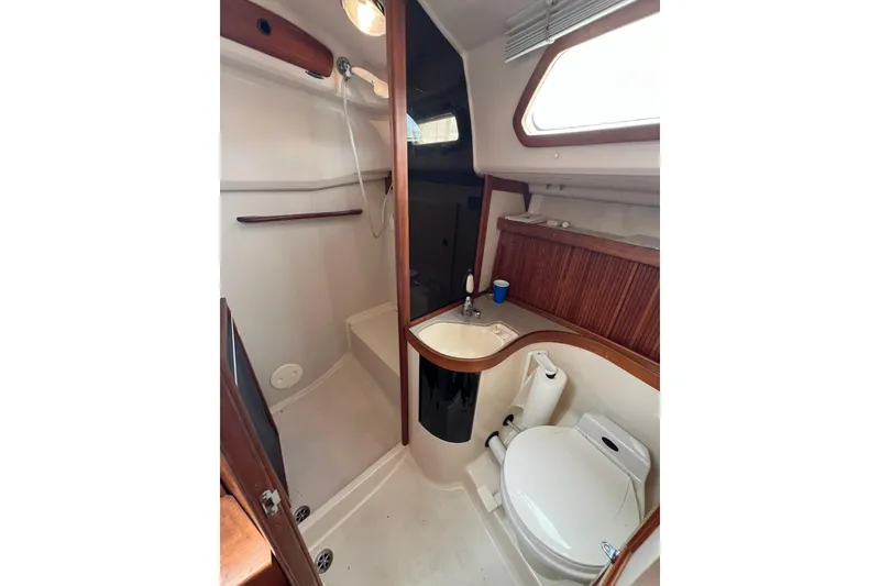 Slide: The Image of Bathroom interior of 1998 Sabre 362 yacht, featuring shower, sink, and toilet. - 34