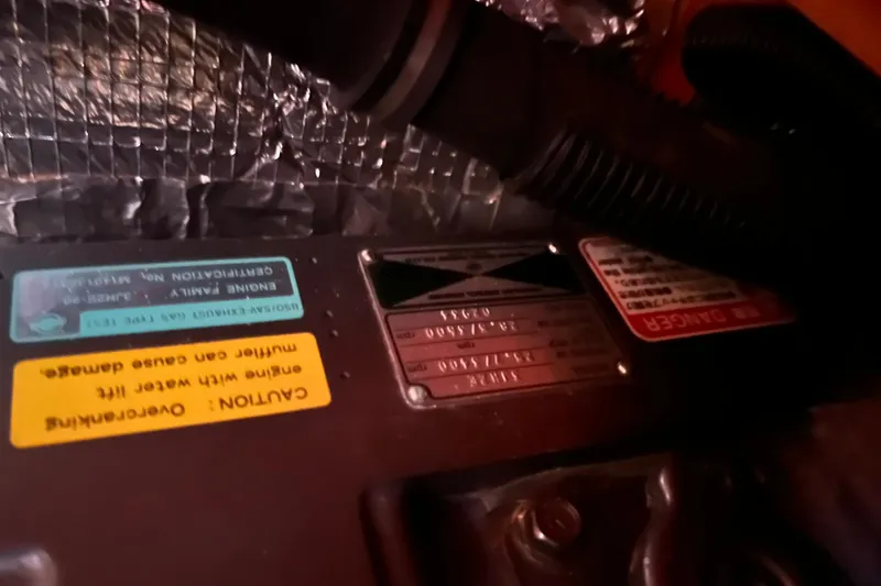 Slide: The Image of Engine compartment of a 1998 Sabre 362 with caution and danger labels visible. - 36