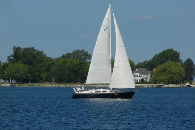 The Image of Sailing yacht Sabre 362 from 1999 gliding on a serene lake with lush greenery. - 0