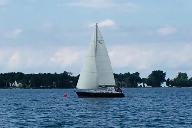 Slide: The Image of Sailing on a serene lake, a 1999 Sabre 362 yacht glides under clear skies. - 2