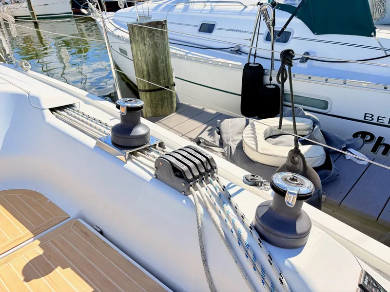 Slide: The Image of Close-up of a sailboat deck with winches and ropes. - 10