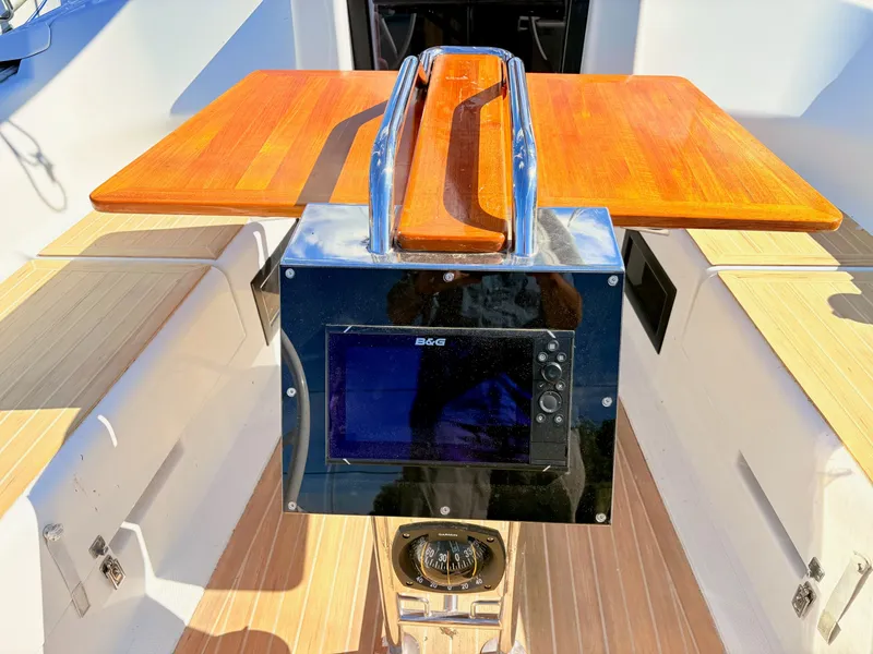 Slide: The Image of A cockpit with a wooden table and navigation system on a Hanse 348 yacht. - 11
