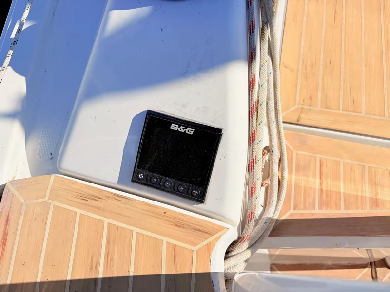 Slide: The Image of Close-up of a boat deck with wood paneling and a B&G navigation device. - 13