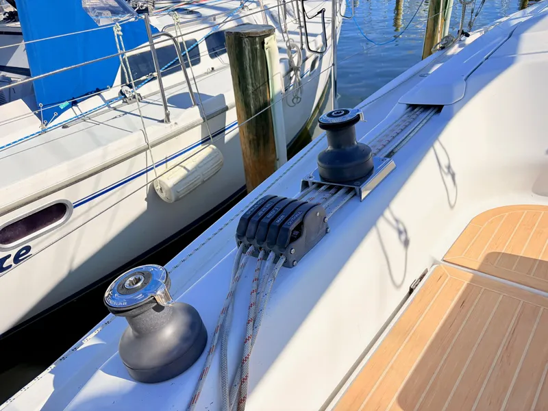 Slide: The Image of Close-up of a sailboat deck with ropes and winches. - 14