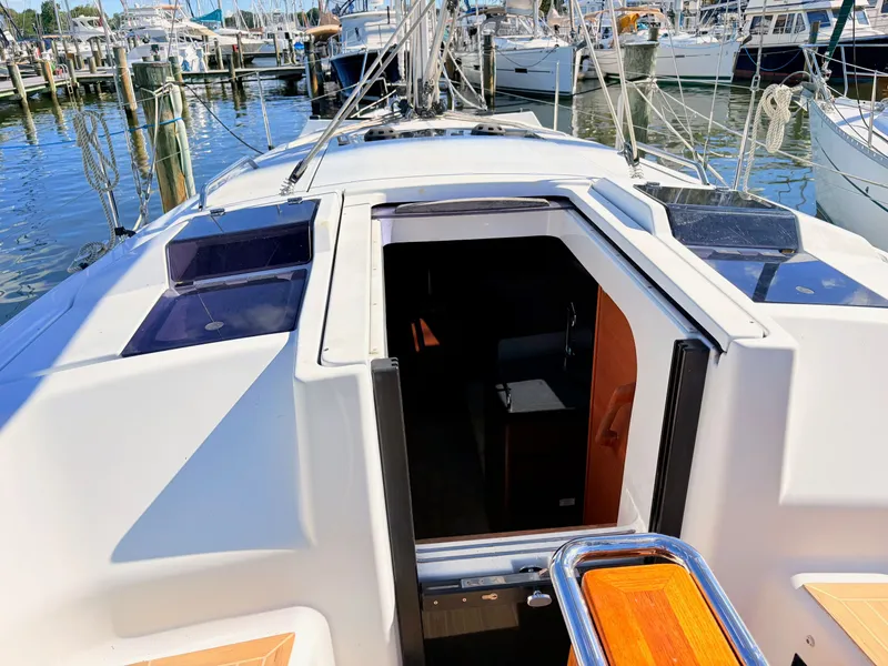 Slide: The Image of The cockpit of a Hanse 348 yacht in a marina, with open access to the interior. - 15