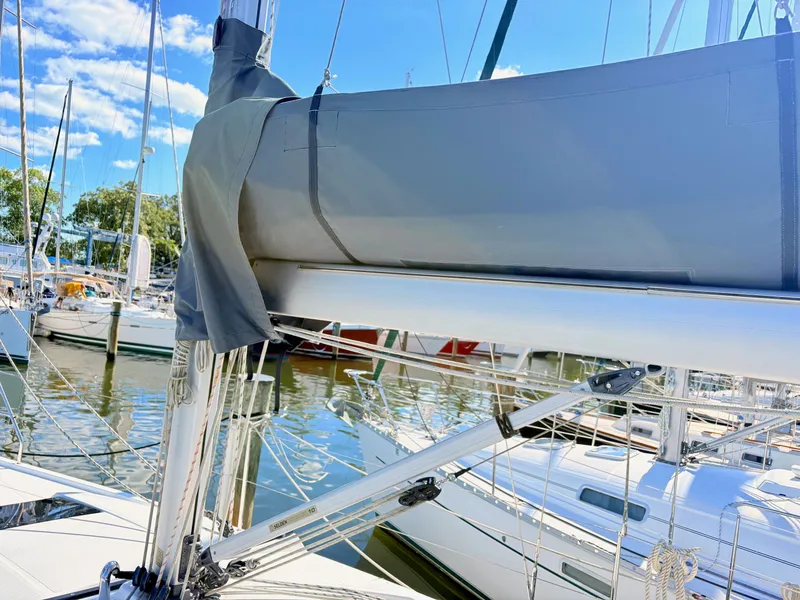 Slide: The Image of A modern sailboat docked in a marina with other boats in the background. - 17