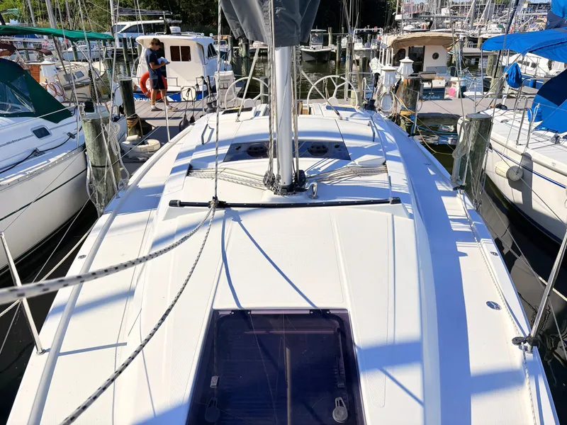 Slide: The Image of The deck of a Hanse 348 yacht in a marina, surrounded by other boats. - 21