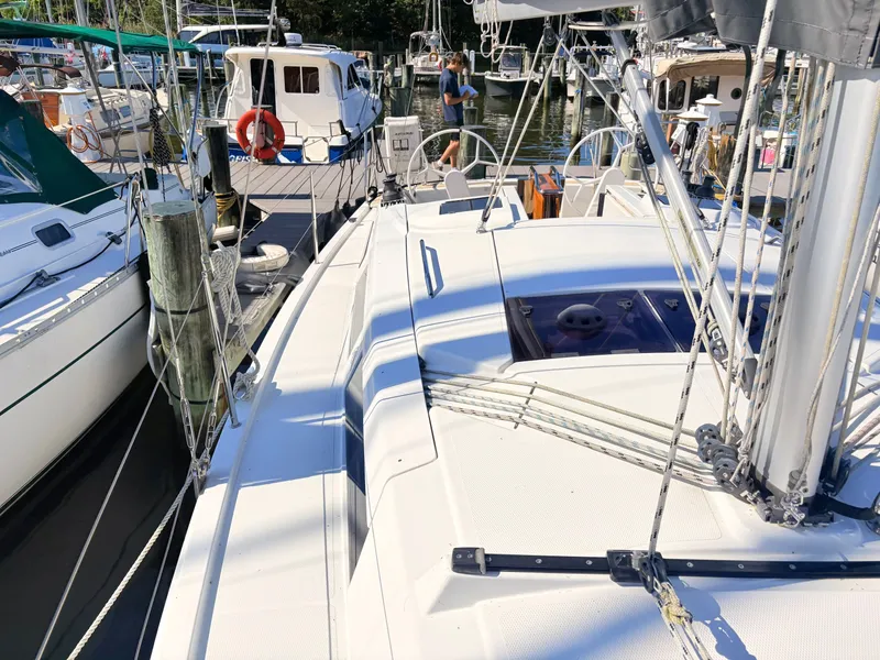 Slide: The Image of A modern sailboat docked in a marina, surrounded by other boats. - 22