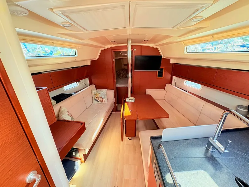 Slide: The Image of Interior of a Hanse 348 yacht with cozy seating and wooden finishes. - 23