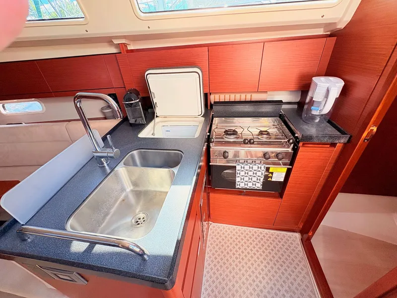 Slide: The Image of The kitchen of a Hanse 348 yacht with a sink, stove, and coffee maker. - 24