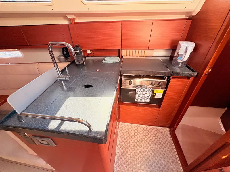 Slide: The Image of The kitchen of a Hanse 348 yacht with a sink, stove, and countertop. - 25