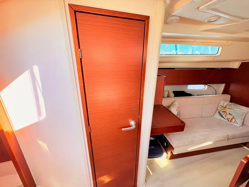 Slide: The Image of Interior of a Hanse 348 yacht with wooden doors and beige sofa. - 26