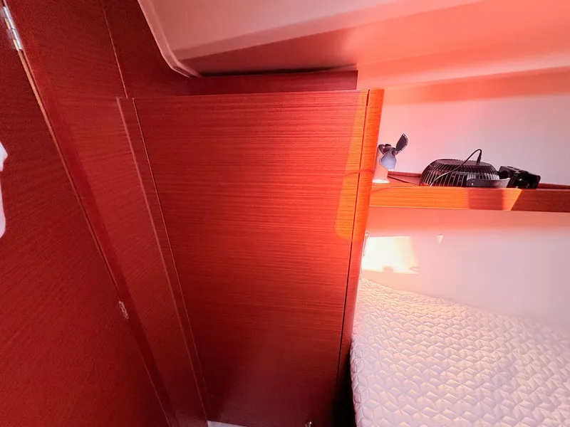 Slide: The Image of Interior of a Hanse 348 yacht with wooden walls and a bed. - 28