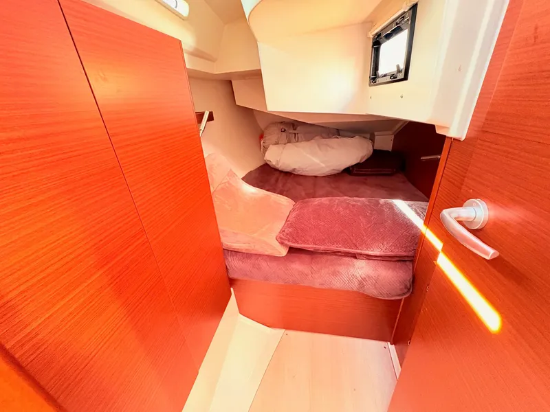 Slide: The Image of Interior of a Hanse 348 yacht with wooden furnishings and a bed. - 30