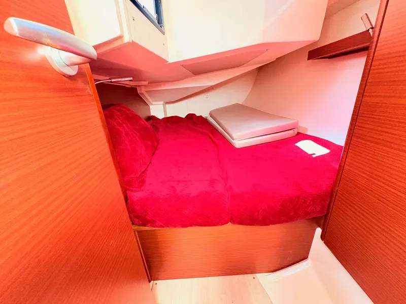 Slide: The Image of A cozy cabin with red bedding on a Hanse 348 boat. - 35
