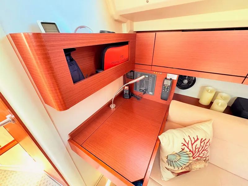 Slide: The Image of Interior of a Hanse 348 yacht with wooden furnishings and a decorative pillow. - 36