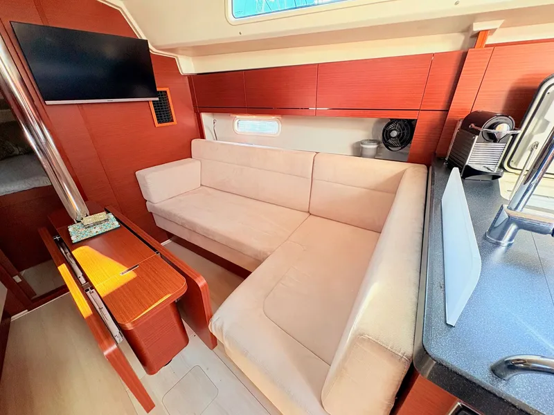 Slide: The Image of Interior of a Hanse 348 yacht with a sofa and kitchenette. - 39