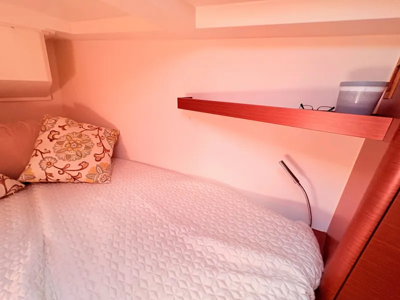 Slide: The Image of Interior of a Hanse 348 yacht with a cozy bed and shelf. - 42