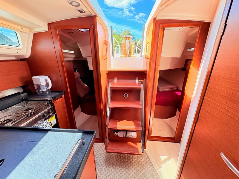 Slide: The Image of Interior of a Hanse 348 yacht with wooden furnishings and stairs leading to the deck. - 44