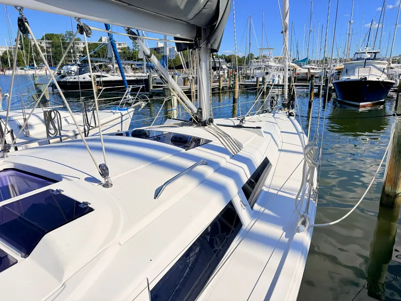 Slide: The Image of A modern sailboat docked in a busy marina. - 48