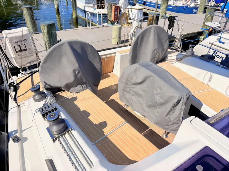 Slide: The Image of The deck of a Hanse 348 yacht in a marina with covers on the seats. - 5