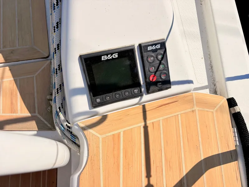 Slide: The Image of Close-up of a boat deck with wood paneling and B&G controls. - 9