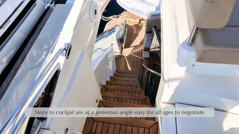 Slide: The Image of Steps leading to cockpit on 2013 Marquis 500 Sport Bridge yacht, featuring teak wood finish. - 12
