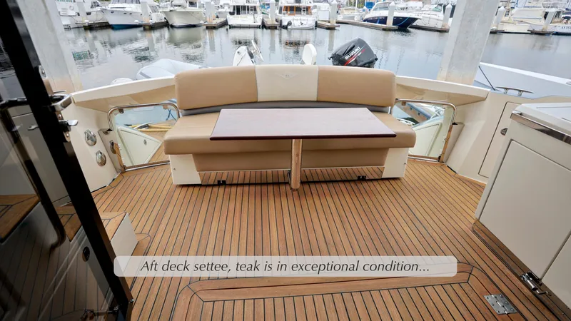 Slide: The Image of Aft deck settee on 2013 Marquis 500 Sport Bridge with teak flooring in excellent condition. - 13