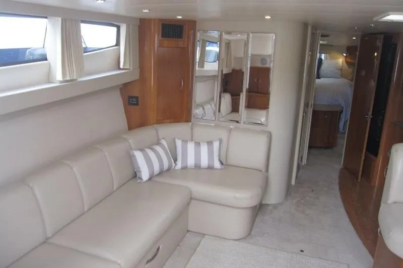 Slide: The Image of Luxurious interior of 2006 Carver 36 Mariner yacht with beige seating and striped pillows. - 2