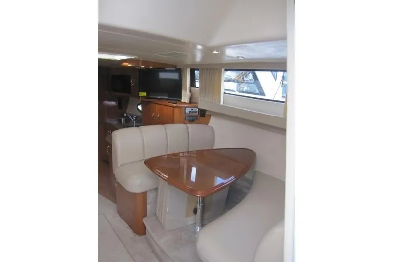 Slide: The Image of Interior of 2006 Carver 36 Mariner yacht with dining area and TV. - 12