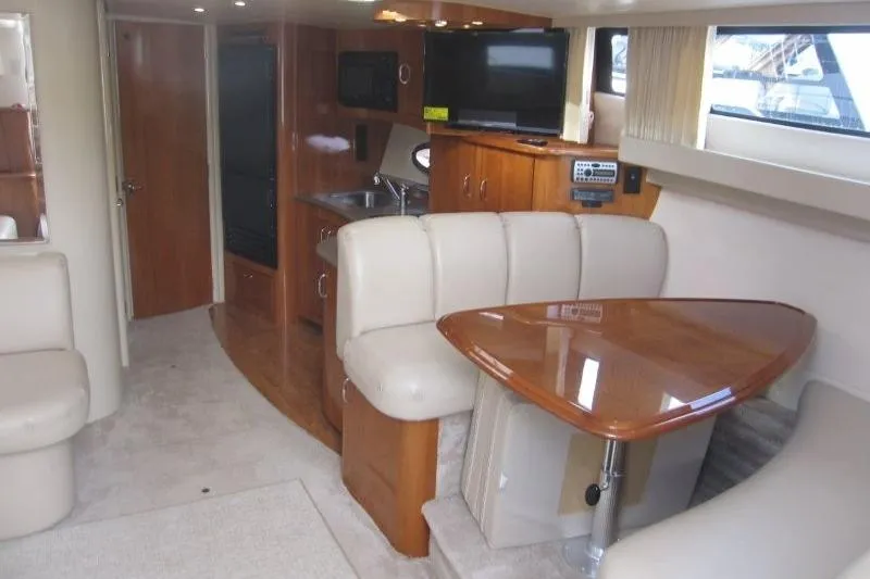 Slide: The Image of Interior of 2006 Carver 36 Mariner yacht with dining area and kitchenette. - 13