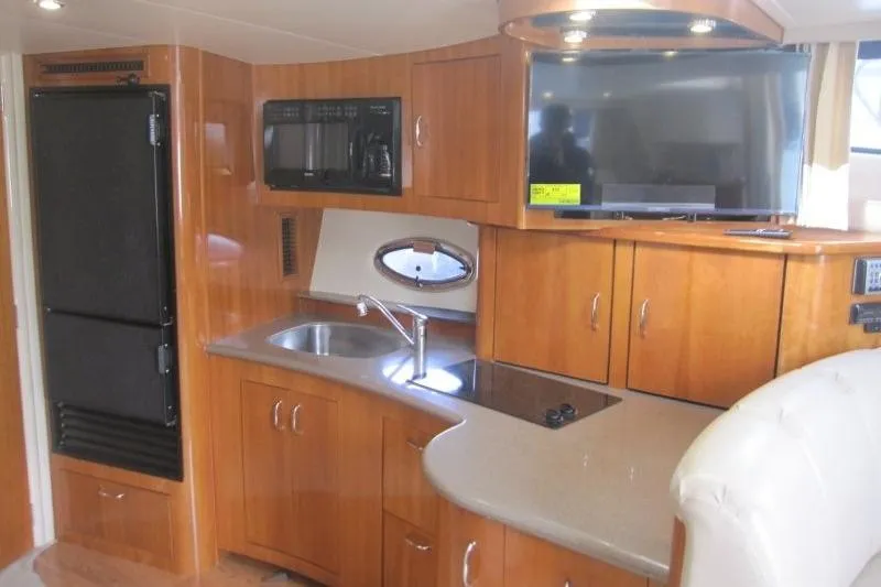 Slide: The Image of Interior of 2006 Carver 36 Mariner yacht with modern kitchen amenities. - 14