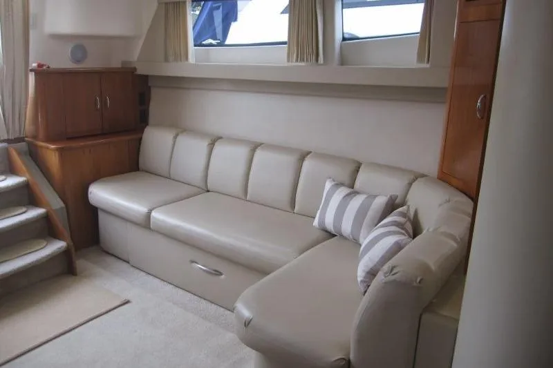 Slide: The Image of Luxurious interior of 2006 Carver 36 Mariner yacht with beige sofa and striped pillow. - 15