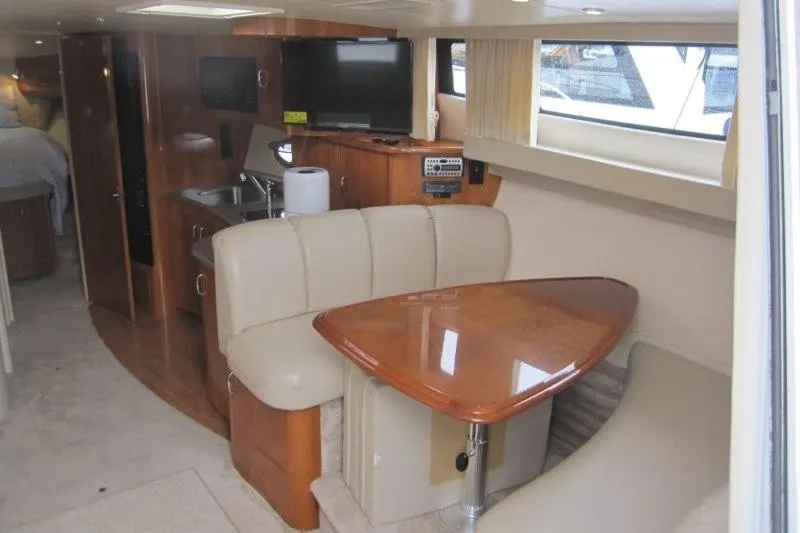 Slide: The Image of Interior of 2006 Carver 36 Mariner yacht with dining area and kitchenette. - 3