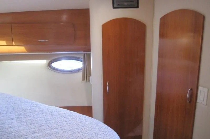 Slide: The Image of Interior cabin of 2006 Carver 36 Mariner with wooden cabinets and porthole window. - 22