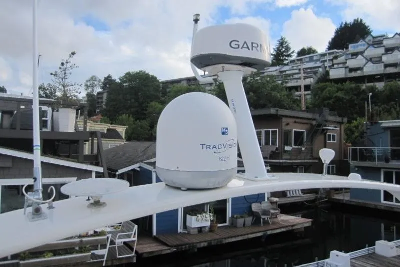 Slide: The Image of 2006 Carver 36 Mariner with Garmin and TracVision equipment, docked near waterfront homes. - 29