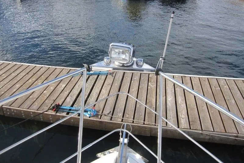 Slide: The Image of Bow view of 2006 Carver 36 Mariner docked at a wooden pier. - 33