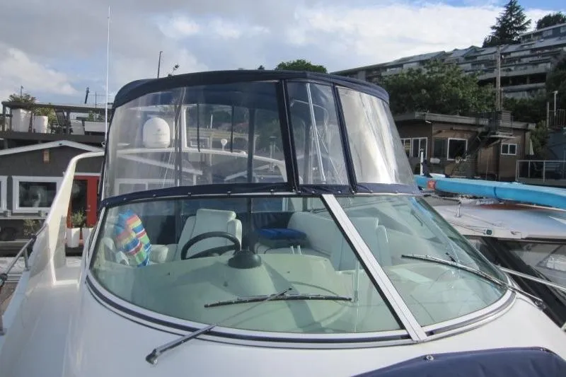 Slide: The Image of 2006 Carver 36 Mariner yacht docked, featuring a sleek windshield and spacious cockpit. - 34